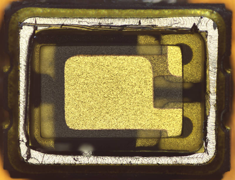 TCXO with open lid showing quartz crystal sheet